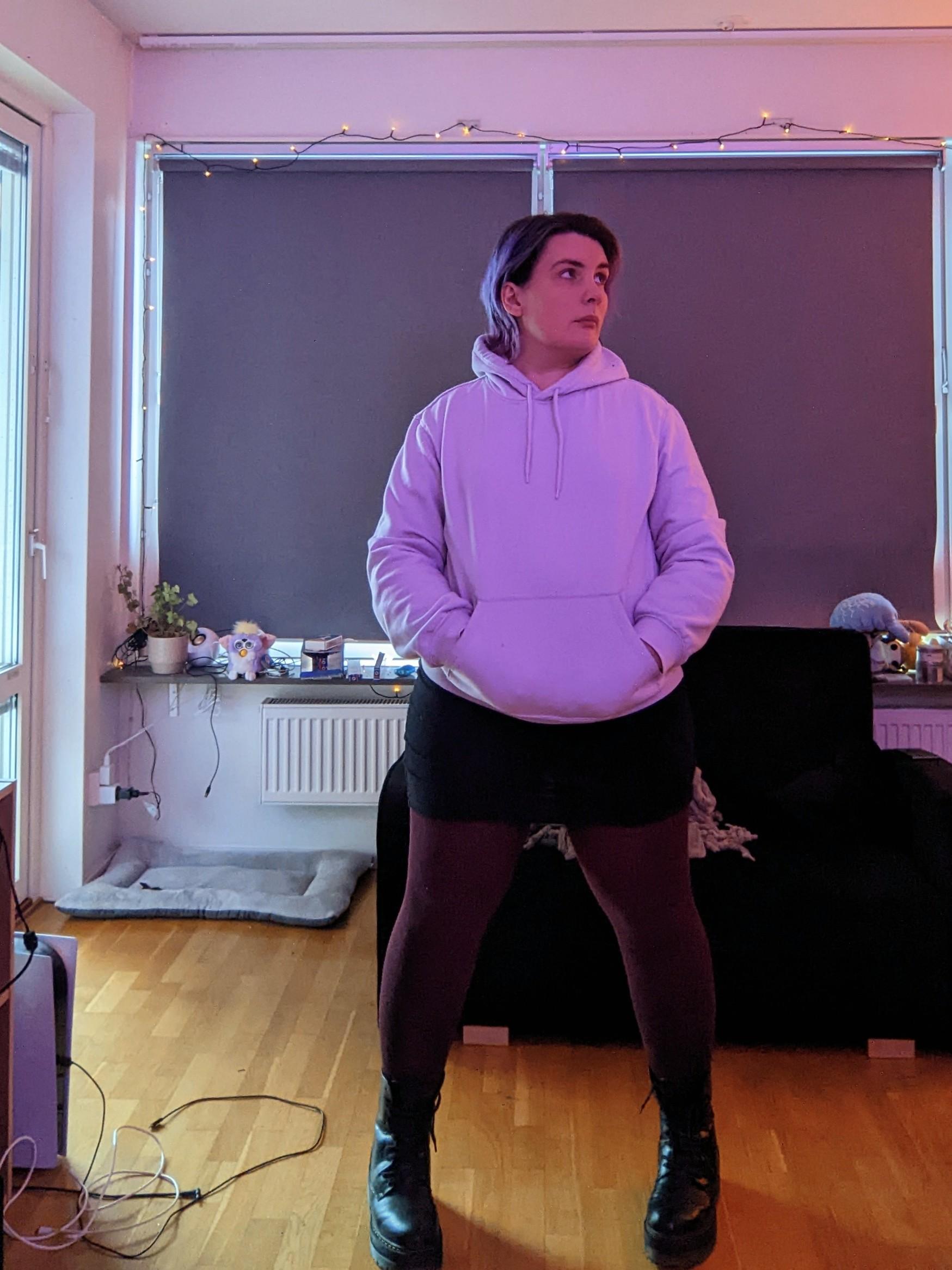 Ash in a lilac hoodie, black miniskirt, burgundy tights, and big black stompy boots looking cute af