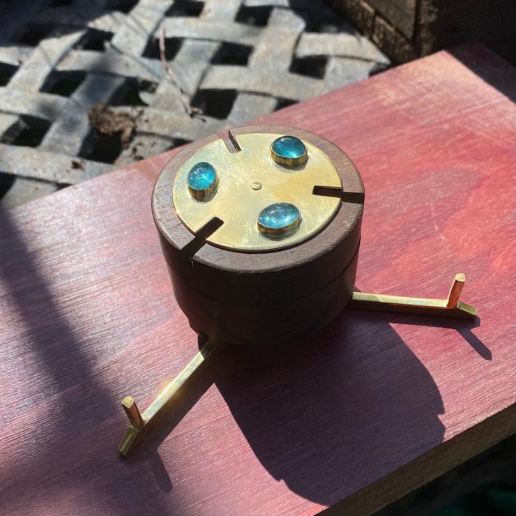 cylindrical ring box made of brass, zircote wood, with aquamarines on top