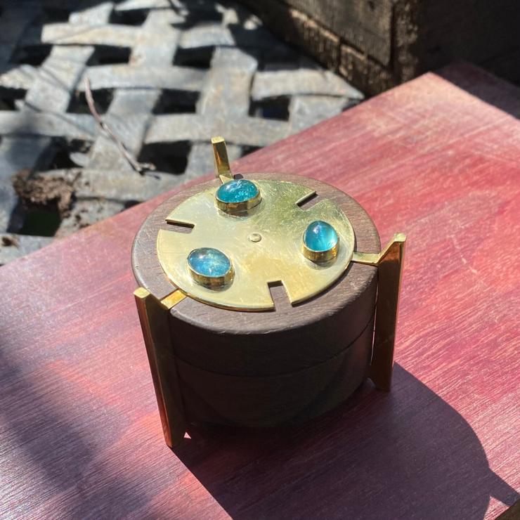 cylindrical ring box made of brass, zircote wood, with aquamarines on top