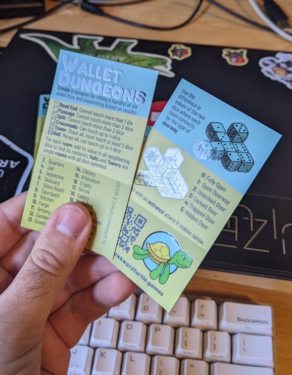 Printed copies of Wallet Dungeons with colorful background, a shiny gloss on the title and art.