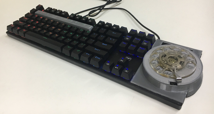 a mechanical keyboard with a rotary phone dial in place of the numpad