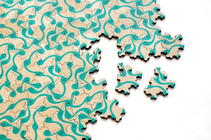 Spectre tile puzzle with a turquoise pattern printed on it 